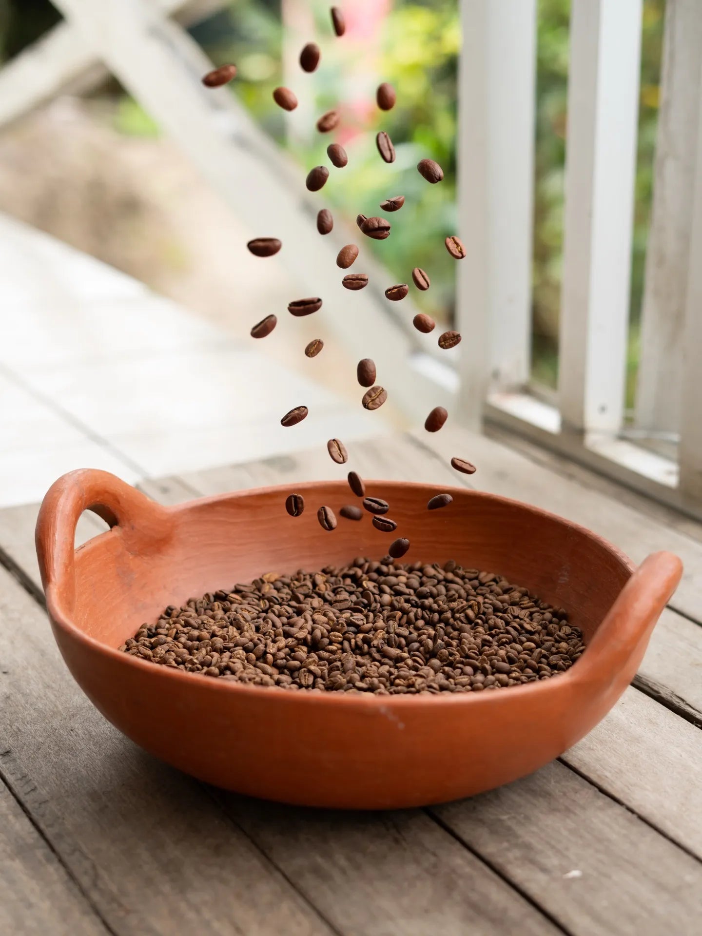 Freshly roasted beans poured into a clay bowl